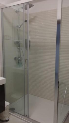 a shower with a glass door in a bathroom at Diva Star Bol in Bol