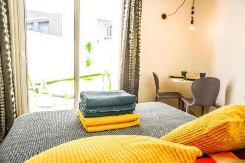 une pile de serviettes posée sur un lit dans l'établissement Studio les Hortensias, à Avignon