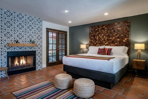 a bedroom with a bed and a fireplace at Santiago Resort - Palm Springs Premier Gay Men’s Resort in Palm Springs