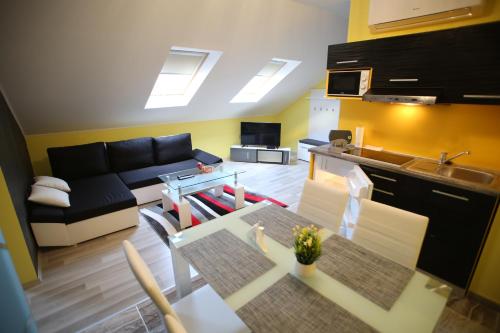 a living room with a couch and a table at Centrum Lux 2 Apartmanok in Kaposvár