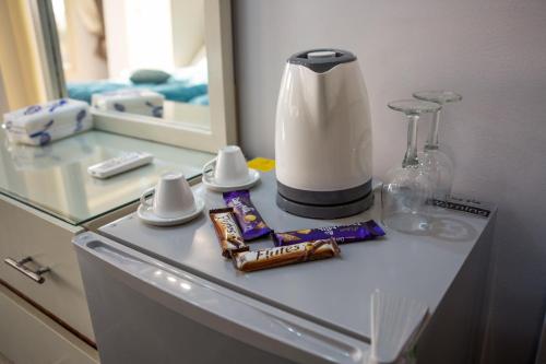 a bathroom counter with a blender and snacks on it at Hayat Pyramids View Hotel in Cairo