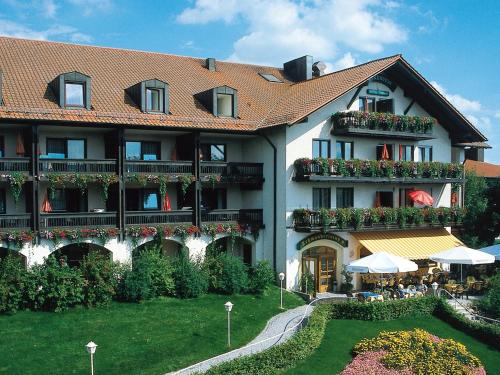 a large building with flowers on the balconies at Hotel Birkenhof Therme in Bad Griesbach