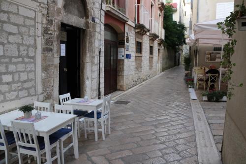 an alley with tables and chairs on a street at Val & Mar Studio Apartment in Zadar