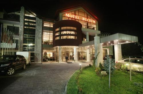 a building with a car parked in front of it at Bucium Motel & SPA in Iaşi