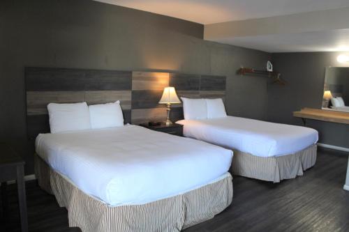 En eller flere senge i et værelse på Cozy Inn