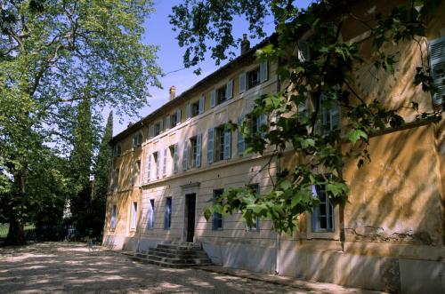 an old building with trees in front of it at Chateau de Saint Martin in Taradeau