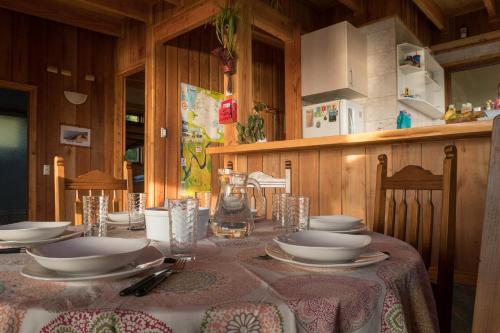 a table with plates and bowls on top of it at Cabañas La Misión in Niebla