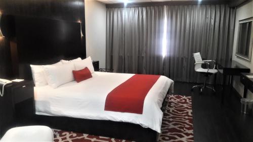 Кровать или кровати в номере Pueblo Amigo Hotel Plaza y Casino