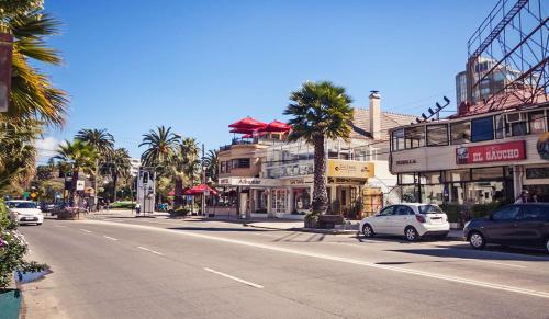 a city street with cars parked on the side of the road at Hotel Albamar in Viña del Mar