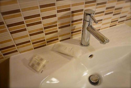 un lavabo con un grifo encima en Hotel Mirella e Ristorante Bar Don Bacco, en Orsago