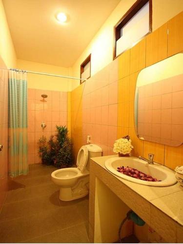 a bathroom with a toilet and a sink and a shower at Sawaddee Aonang Resort in Ao Nang Beach