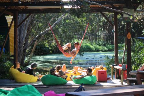 a group of people sitting on inflated balls in the water at Arts Factory by Nomads in Byron Bay