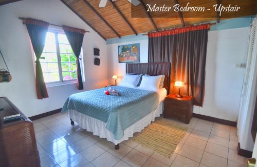 a bedroom with a bed with two teddy bears on it at Moon San Villa at the Blue Lagoon in Port Antonio