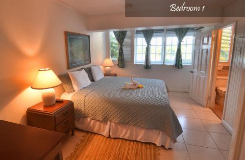 a bedroom with a bed with a stuffed animal on it at Moon San Villa at the Blue Lagoon in Port Antonio