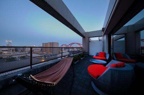 a balcony with hammocks and a view of a city at Hotel Eldia Luxury Kobe (Adult Only) in Kobe