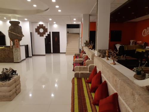 a lobby with a row of couches in a building at Hotel Cristales De Sal in Uyuni
