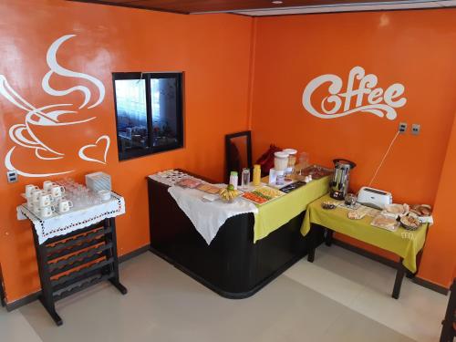 a coffee shop with two tables and a sign on the wall at Hotel Cristales De Sal in Uyuni