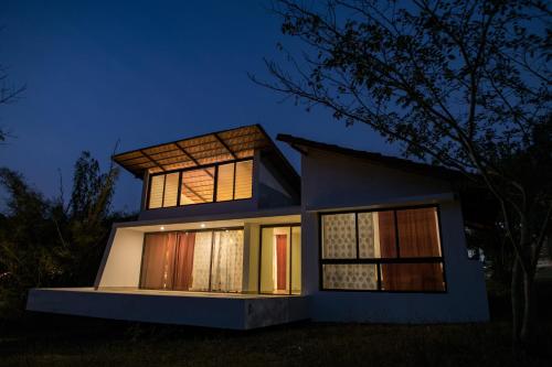 a house lit up at night at Dhole's Den Bandipur in Bandipūr