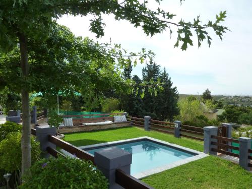 a swimming pool in the yard of a house at A Hilltop Country Retreat in Swellendam