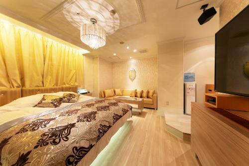 a bedroom with a bed and a flat screen tv at i RESORT ARTIA Luxury Gifu (Adult Only) in Gifu