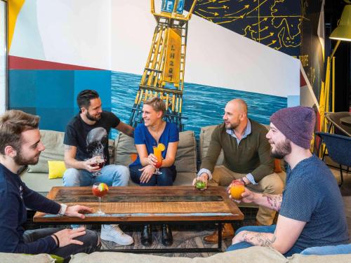 a group of people sitting around a table at Mercure Le Havre Centre Bassin Du Commerce in Le Havre