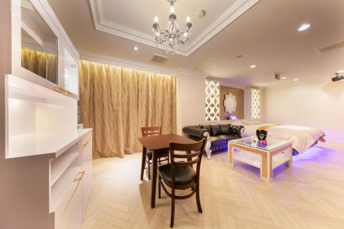 a bedroom with a bed and a table and a dining room at i RESORT ARTIA Luxury Gifu (Adult Only) in Gifu