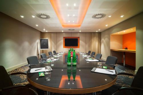 a conference room with a long table and chairs at Apex City Of London Hotel in London