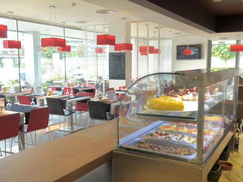 a restaurant with a buffet of food on display at Ibis Lleida in Lleida