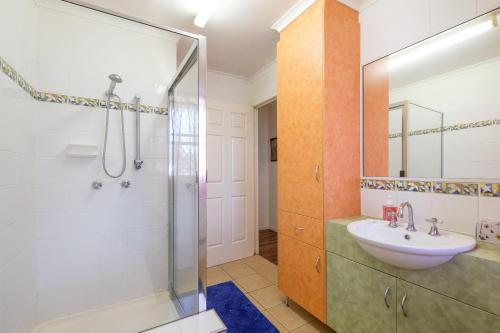 a bathroom with a shower and a sink at Home at Southside Central in Bundaberg
