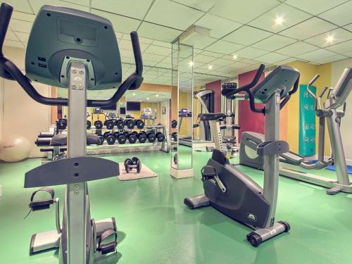 a gym with several treadmills and exercise bikes at Mercure Paris Velizy in Vélizy-Villacoublay