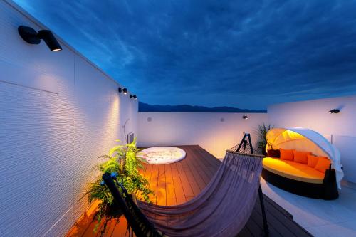 a hammock room with a couch and a table at Hotel Eldia Yamanashi (Adult Only) in Fuefuki