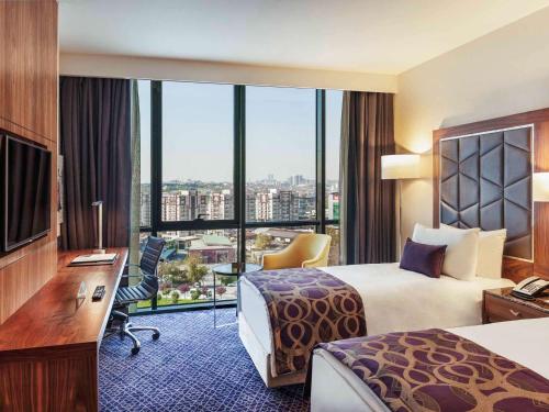 a hotel room with a bed and a desk with a computer at Uranus Istanbul Topkapi in Istanbul