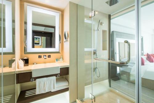 a bathroom with a shower and a sink at Novotel Nanjing Central in Nanjing