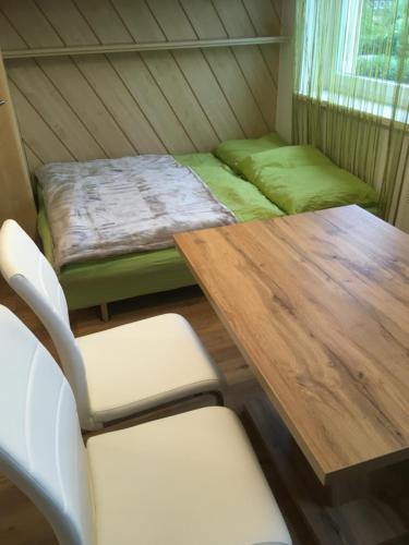 a room with a table and chairs and a bed at My apartment in Zeltweg