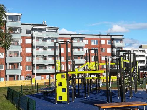 a playground in front of an apartment building at Arctic Oasis Apartments in Rovaniemi