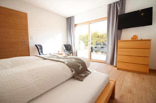 a bedroom with a bed and a sliding glass door at Haus Piz Lad in Nauders