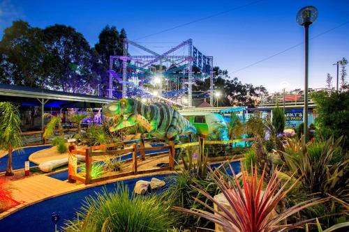 a dinosaurs exhibit at a theme park at night at BIG4 Traralgon Park Lane Holiday Park in Traralgon