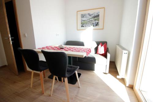 a small dining room with a table and chairs at Haus Piz Lad in Nauders