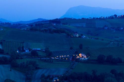 a view of a field at night with a mountain at Agriturismo Vecchio Gelso in Ortezzano