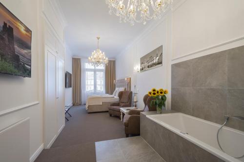 a bathroom with a bath tub and a living room at Apartmány Arte in Brno