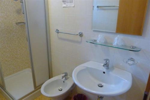 a bathroom with a sink and a shower at Garni Cremona in Bressanone