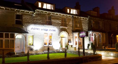 an apartment building with lights on the front of it at The Abbey Lodge Hotel in Bradford