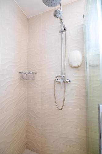 a shower with a glass door in a bathroom at Petit Malaga Congress in Málaga