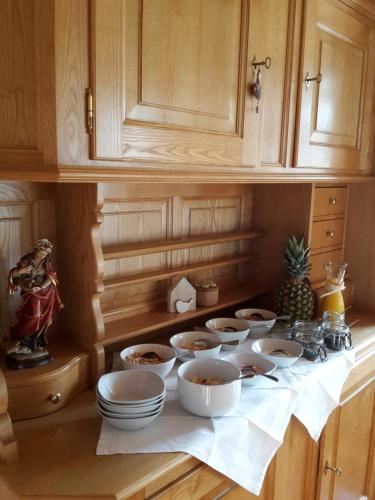 a kitchen with bowls and plates on a counter at Gästehaus Appartements Egender in Bezau