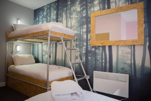 a bedroom with two bunk beds and a mirror at Sleep Eat Love in Liverpool