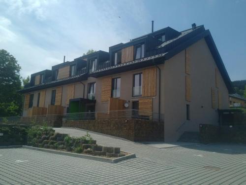 a large house with a lot of windows on it at Apartmány Sport Dolní Morava in Dolní Morava