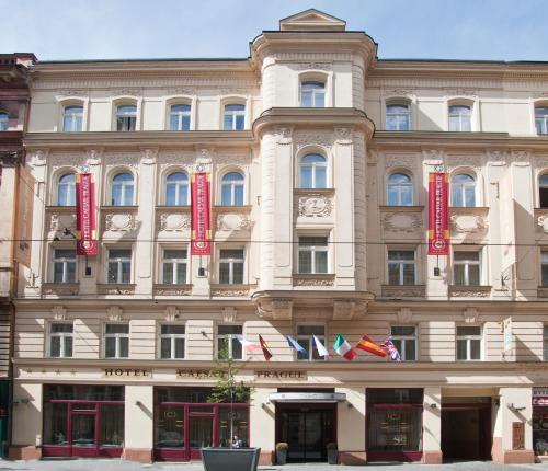 a large building with red signs on it at Hotel Caesar Prague in Prague