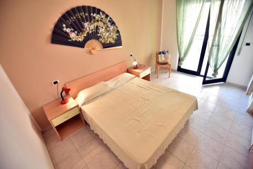 a bedroom with a bed and a large window at Residence Adriatico in Silvi Marina