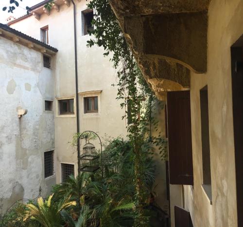 an outside view of a building with plants at Hotel Gabbia D'Oro in Verona