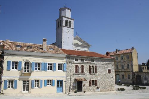 a building with a clock tower on top of it at Terra Mirna in Vižinada